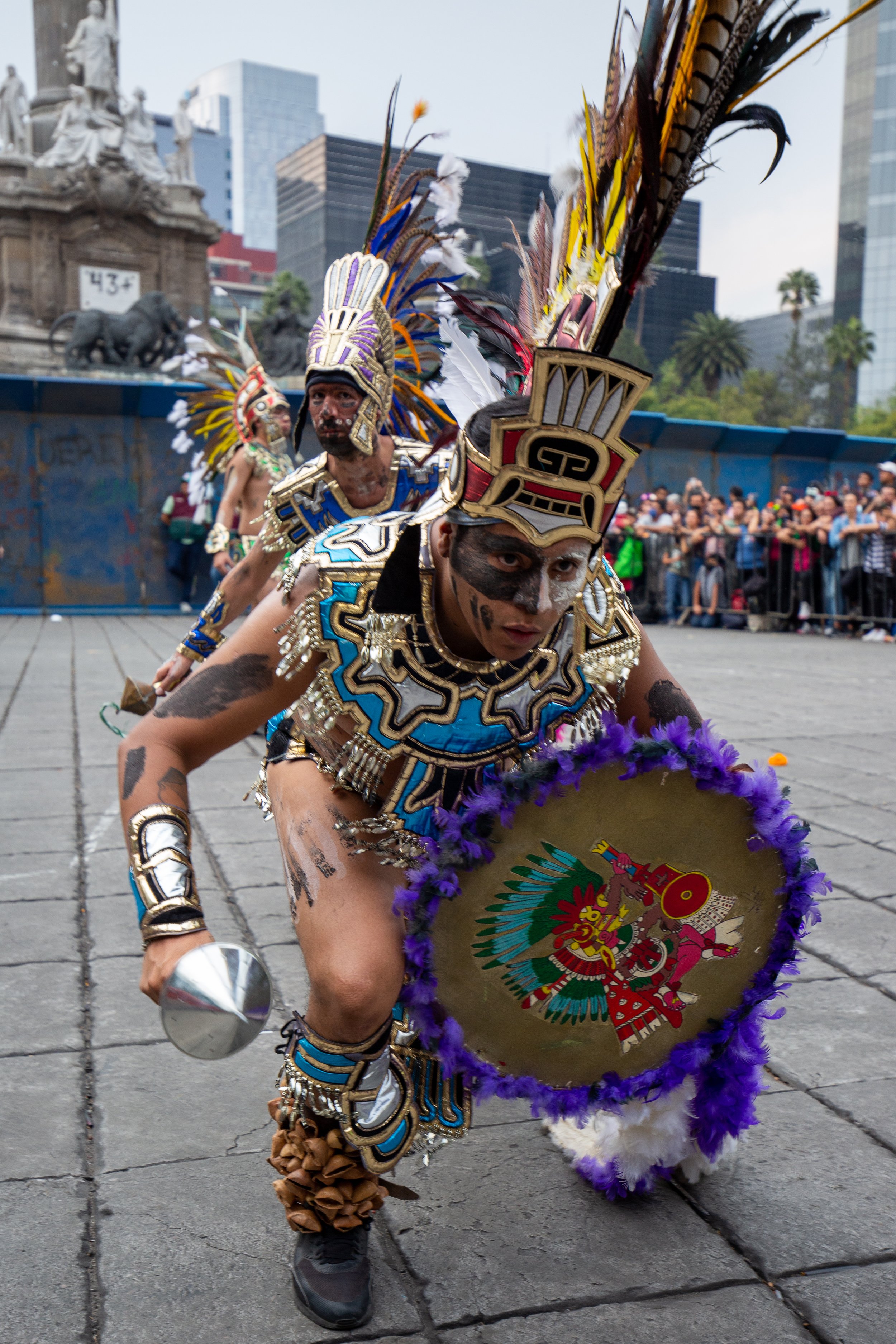 During Día de los Muertos, paraders dress and march as Aztec warriors on the streets of Mexico City.