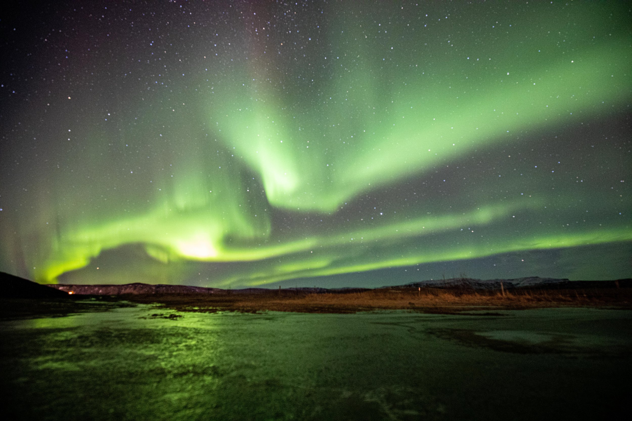 The northern lights dance and shine over Iceland.
