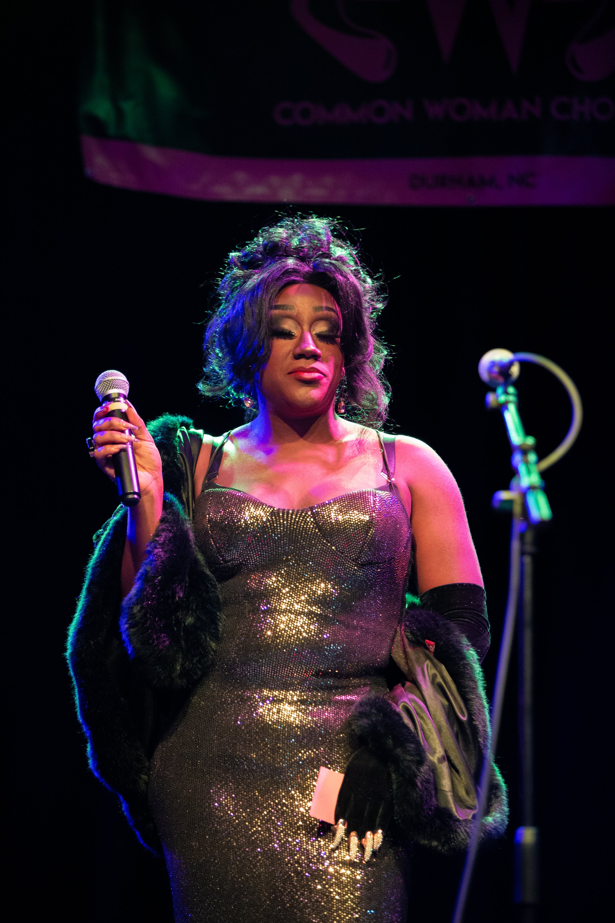 Stormie Daie smolders at the microphone stand while emceeing a cabaret performance hosted by the Common Woman Chorus in Durham, North Carolina.