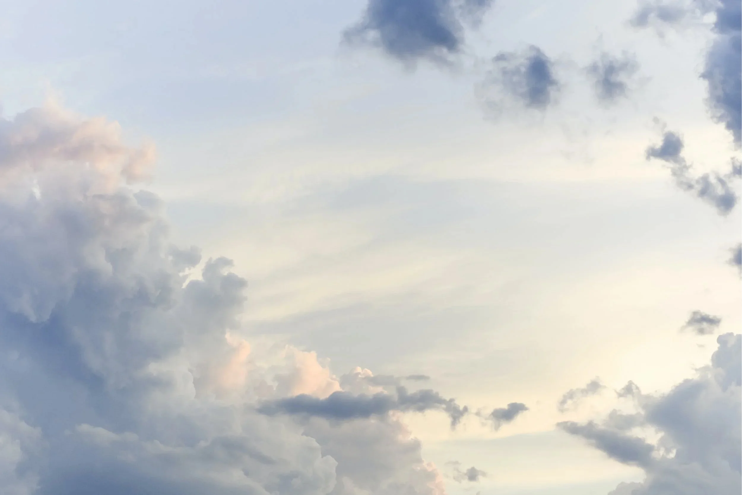 Overcast sky with scattered dark and light gray clouds.