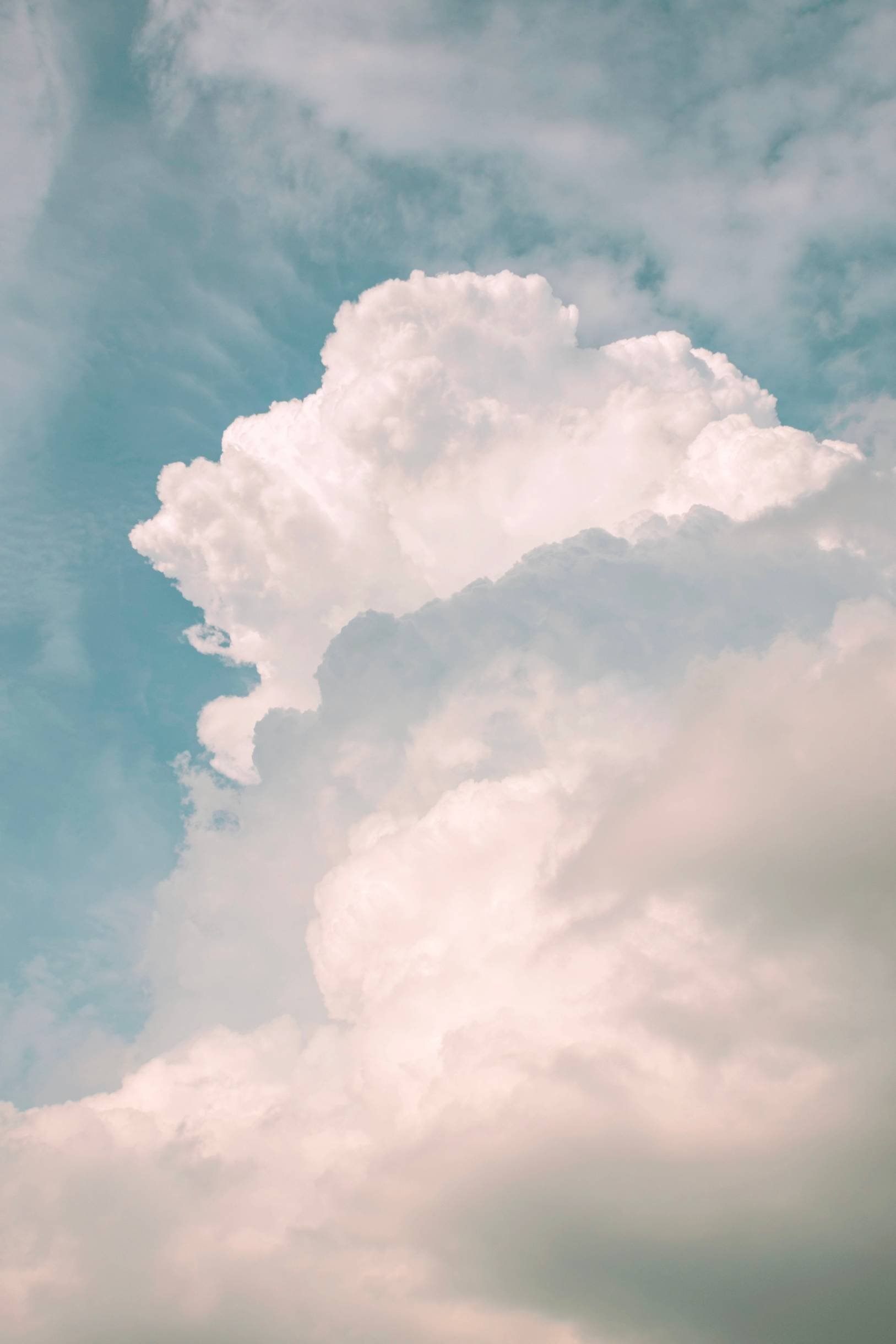 Sky with large fluffy white clouds and light blue sky.