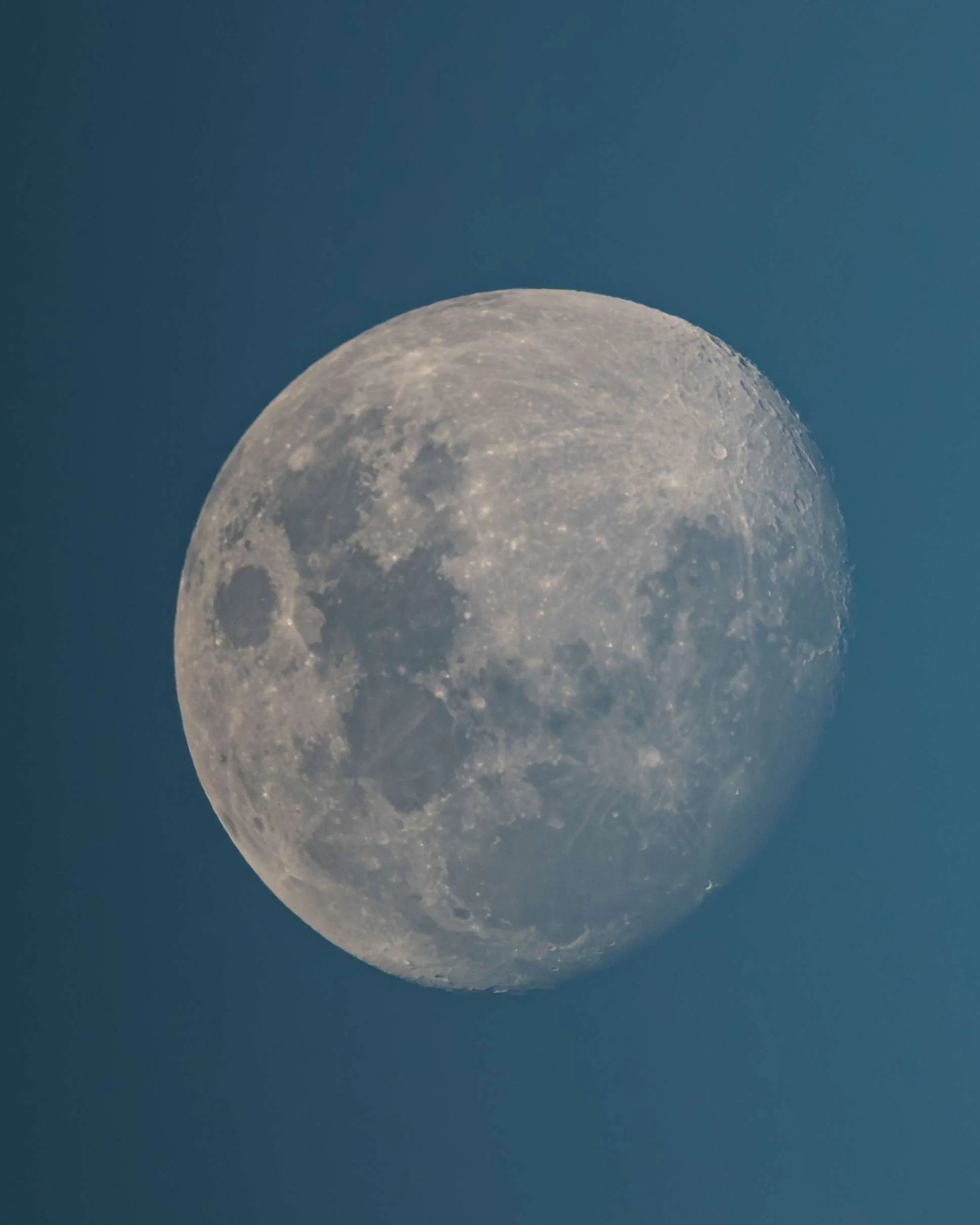 Close-up of the moon showing craters and surface details against a dark sky.