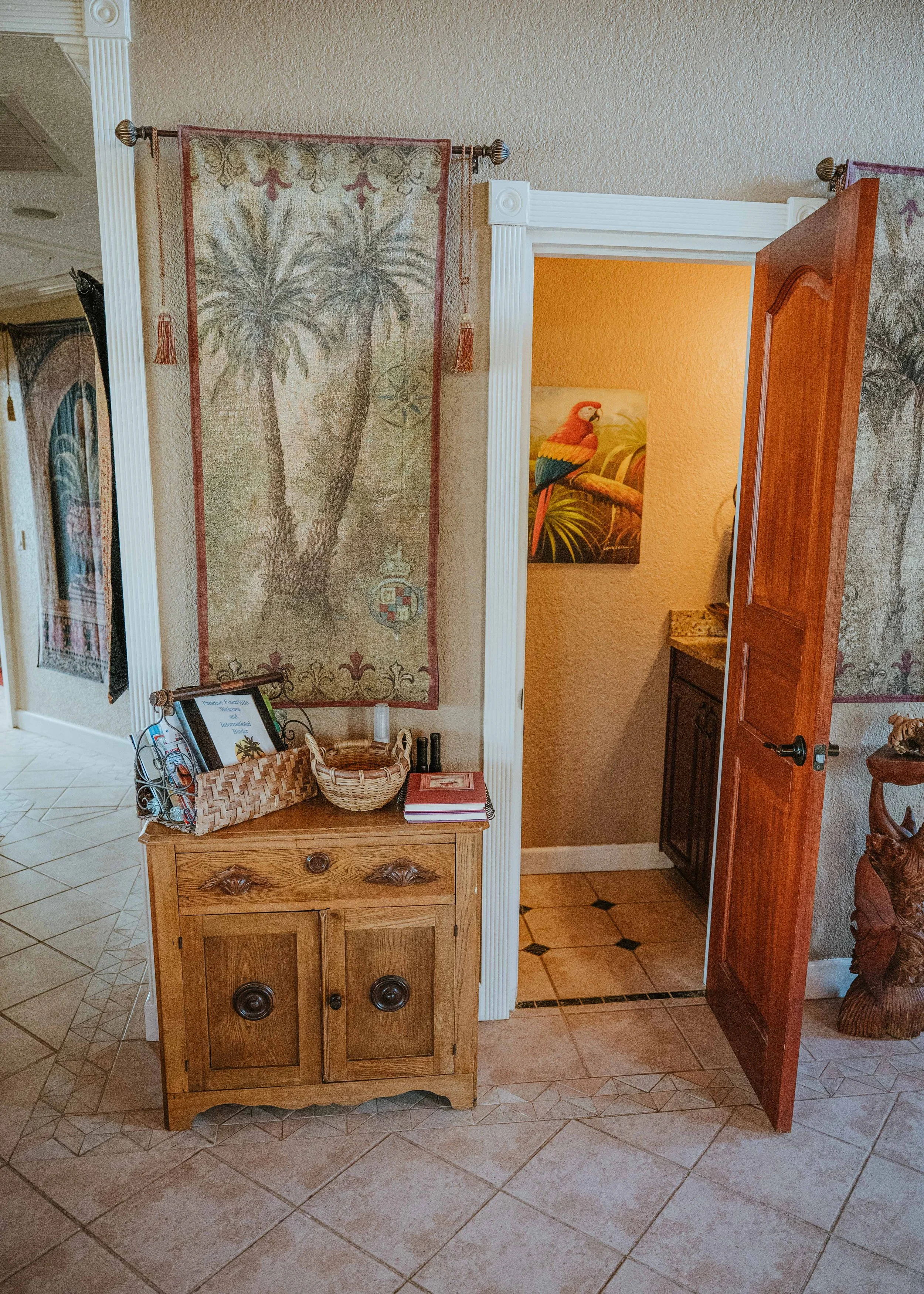 Hallway door open showing the bathroom sink and parrot wall art
