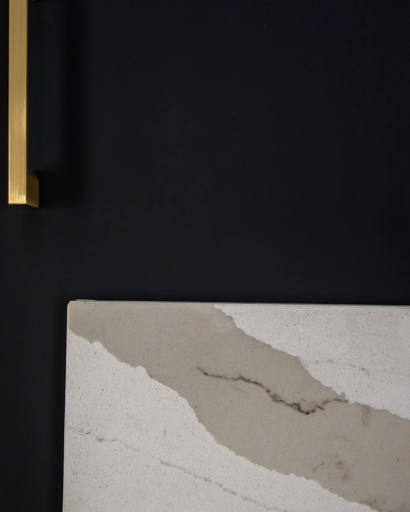 Less noise. More intention. When every element earns its place in the room, the result speaks for itself. Matte black. Brushed brass. Porcelain slab countertop. Three materials, one flawless moment. 

Matte Black Frameless Cabinetry | @orangecabinetr