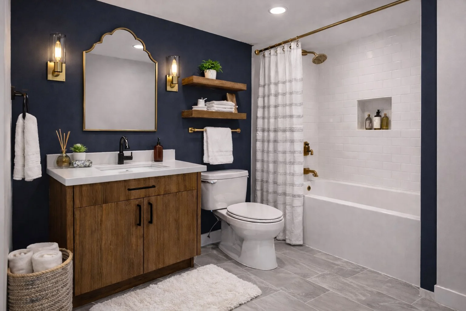 Modern bathroom with navy blue accent wall, wooden vanity, white sink, large mirror, wall-mounted light fixtures, floating wooden shelves with towels and plant, toilet, shower with white brick wall, built-in shelves, and white curtain.