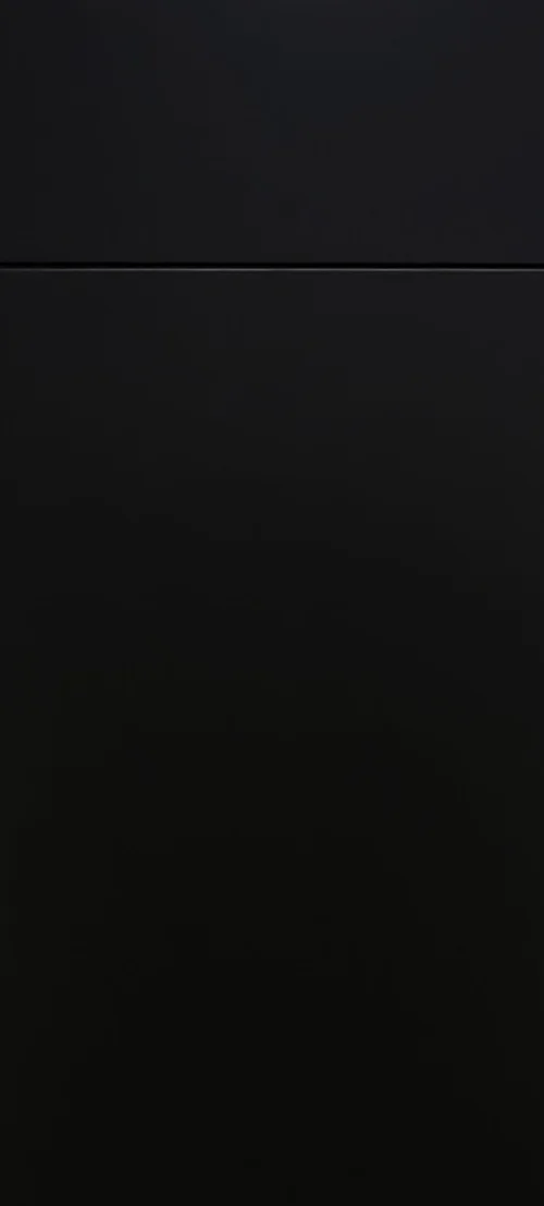 Close-up of a black, smooth surface with a horizontal line dividing two sections.