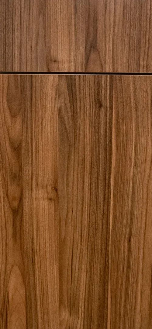 Close-up of a wooden surface with natural wood grain patterns and a horizontal seam.