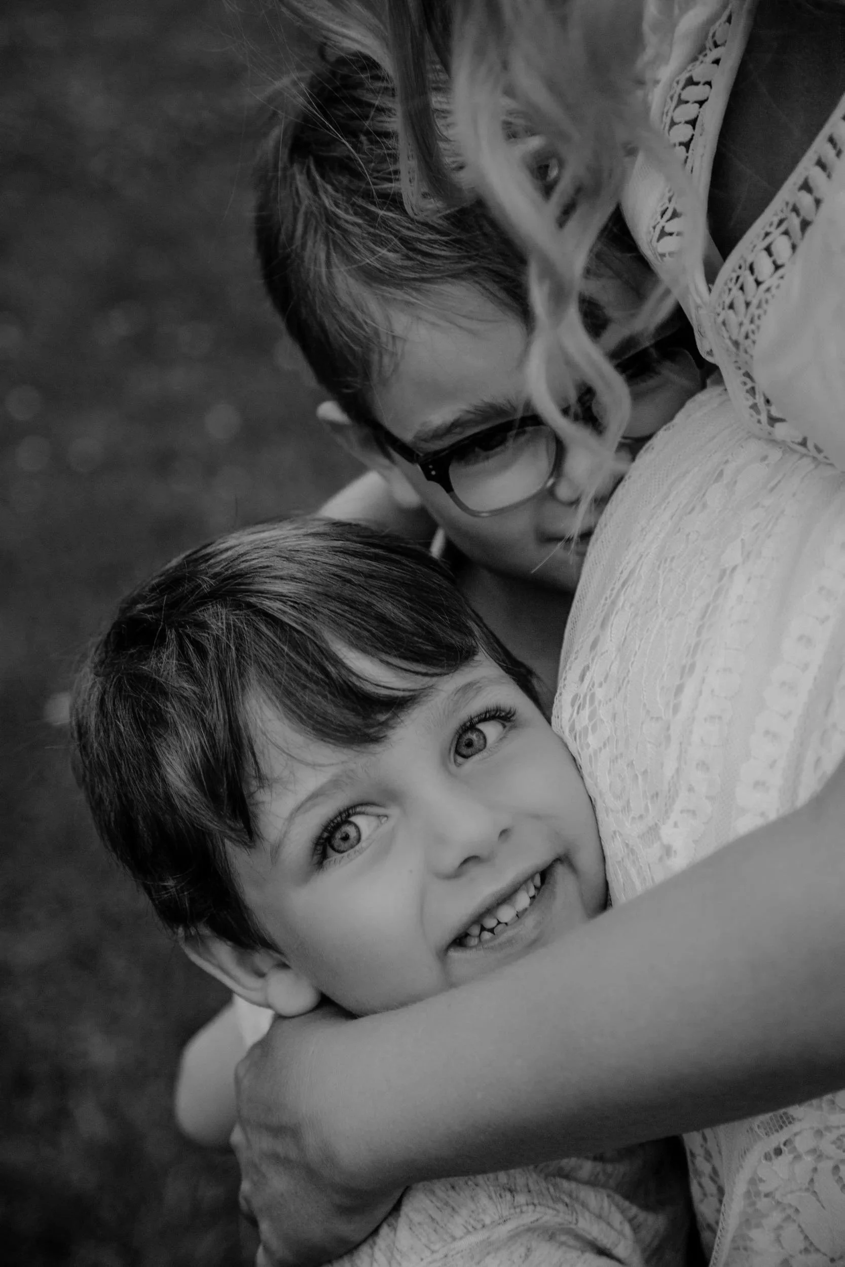 Mt Juliet Family posing during family photos while boy hugs his pregnant mom, smiling