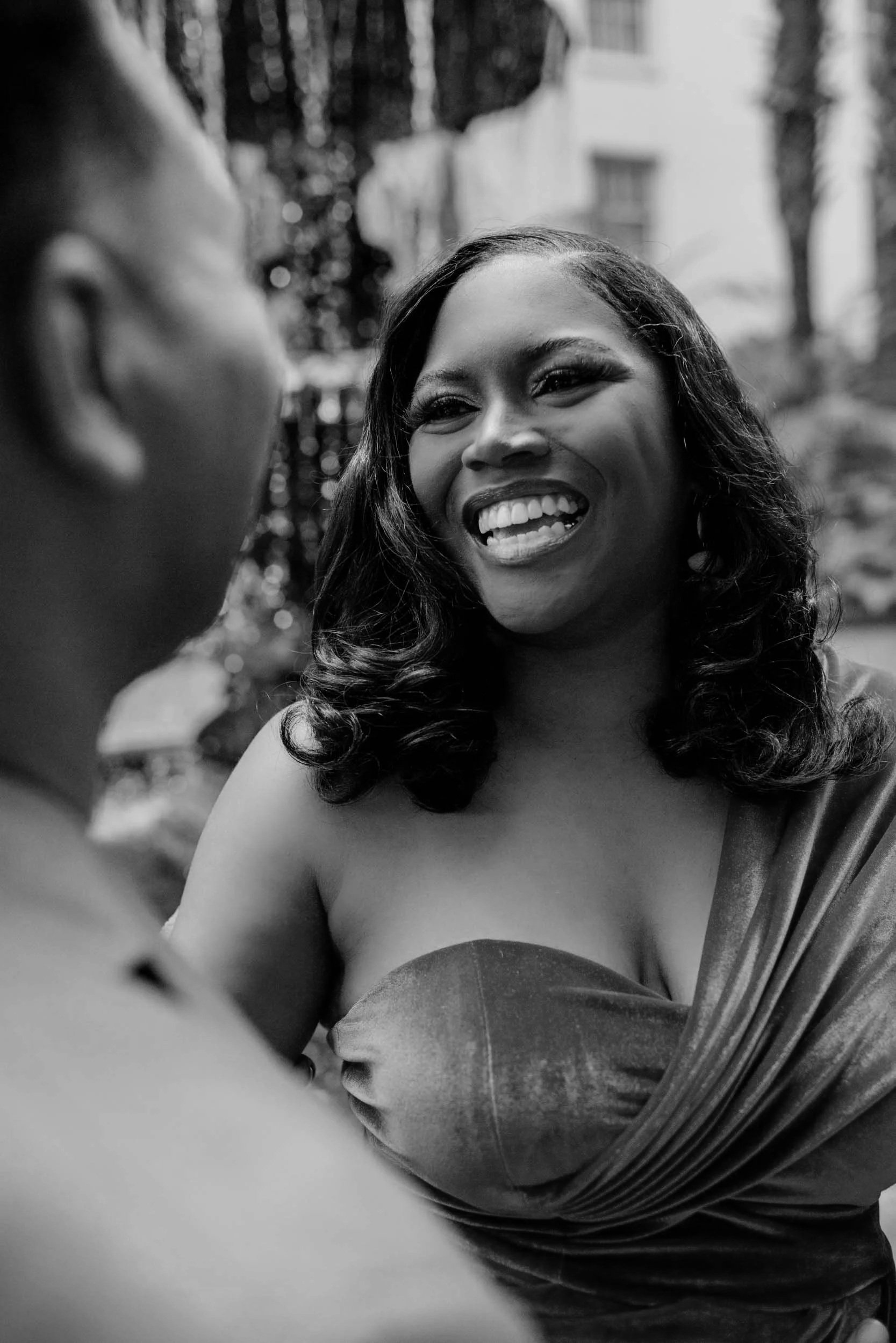 nashville couple smiling at each other during an engagement shoot at Opryland in Nashville TN