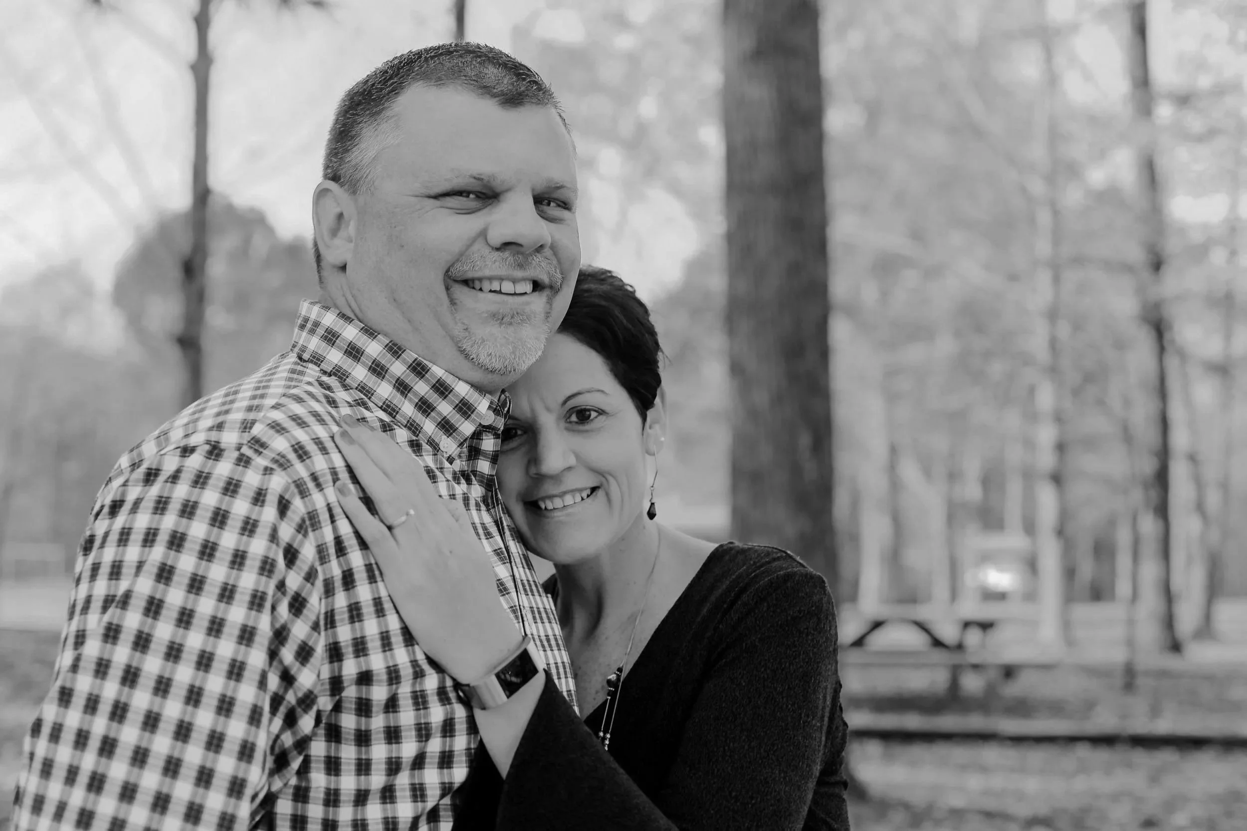 Engaged couple pose for pictures in Nashville Park during the fall