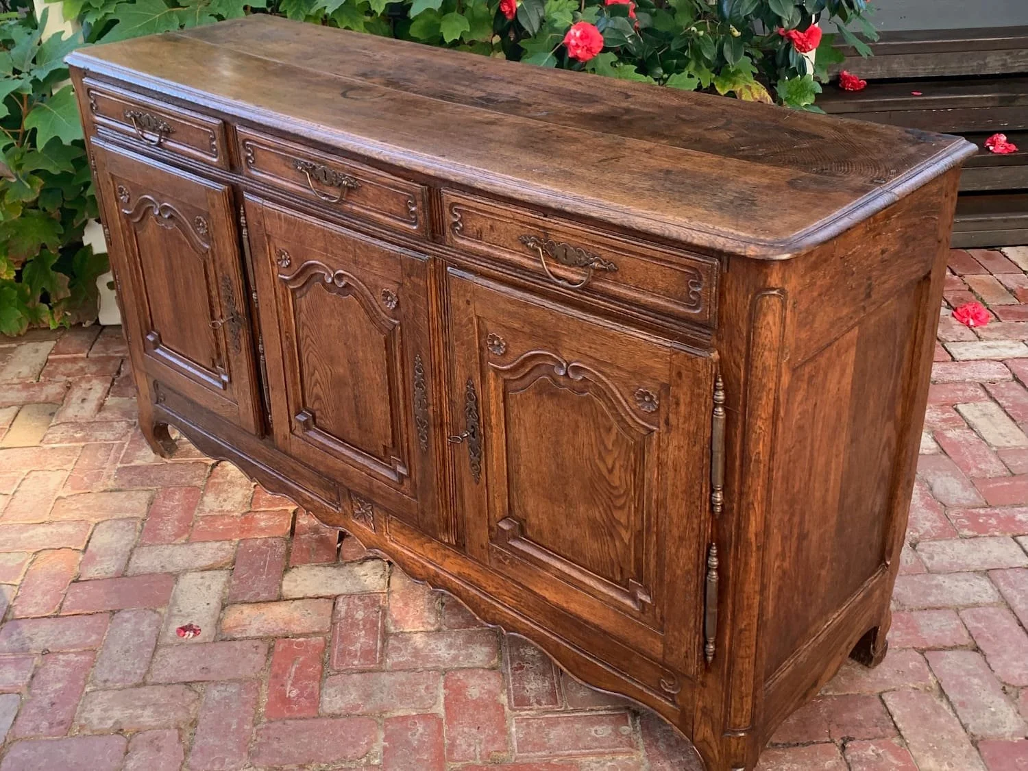 Angled view of French oak enfilade sideboard, c.1740-1760, showing depth and turned column detailing