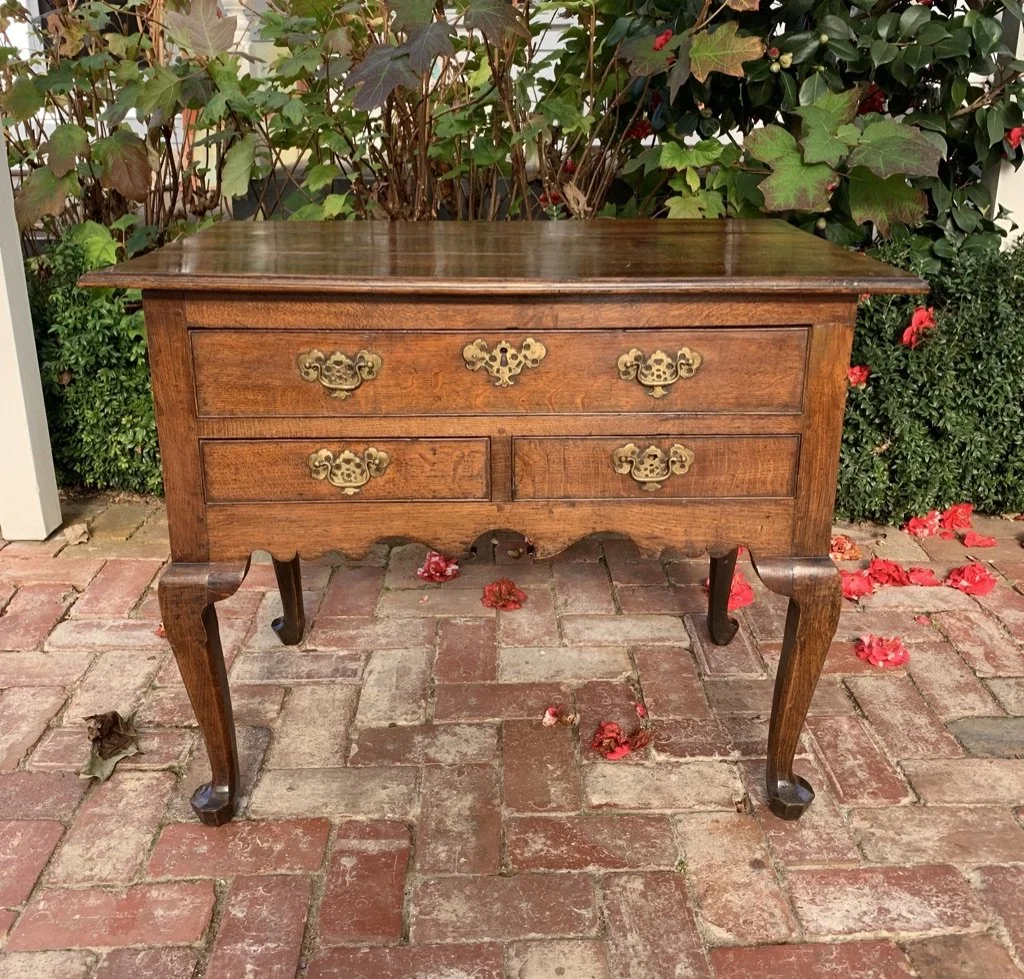 George II oak lowboy c.1730–1750, one long over two short drawers, brass bat's-wing handles, cabriole legs, pad feet — front view