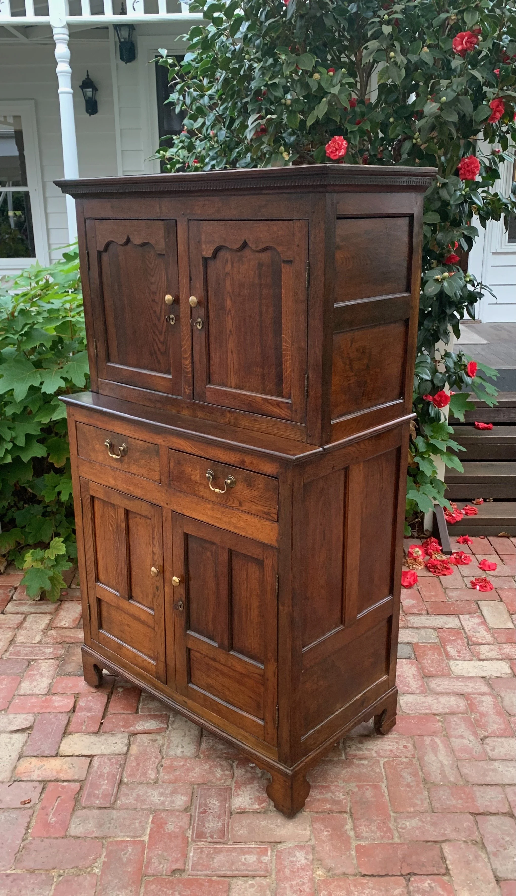 18th century Welsh oak cwpwrdd deuddarn cupboard, dentil cornice and fielded doors, angled view showing full depth