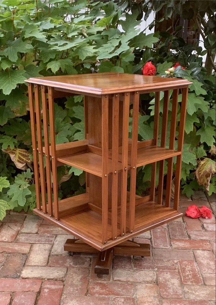 Edwardian walnut revolving bookcase c.1910 two-tier brass studs cruciform base