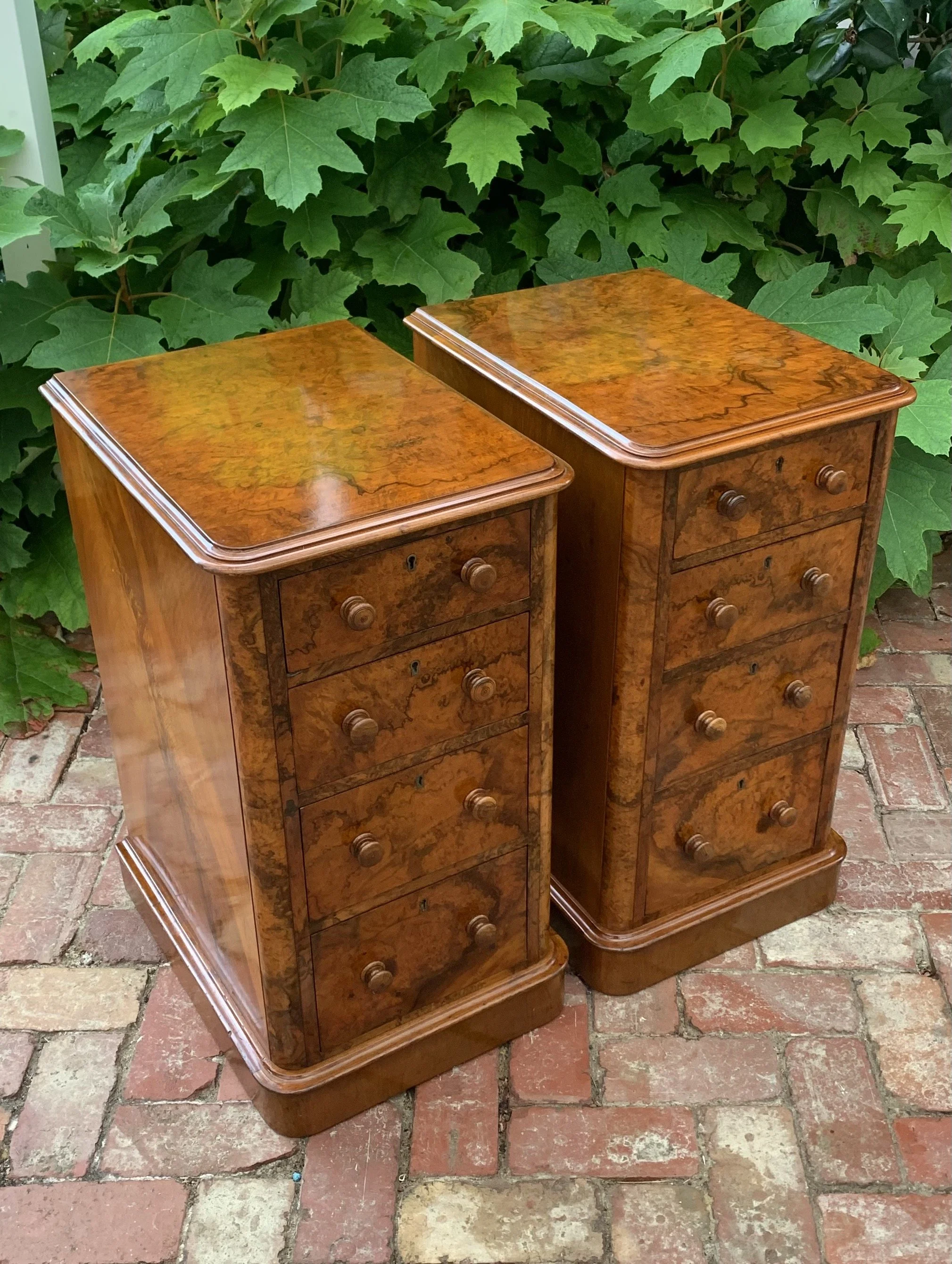 angled view of pair of antique burr walnut bedside chests with graduating drawers and turned knobs circa 1870 