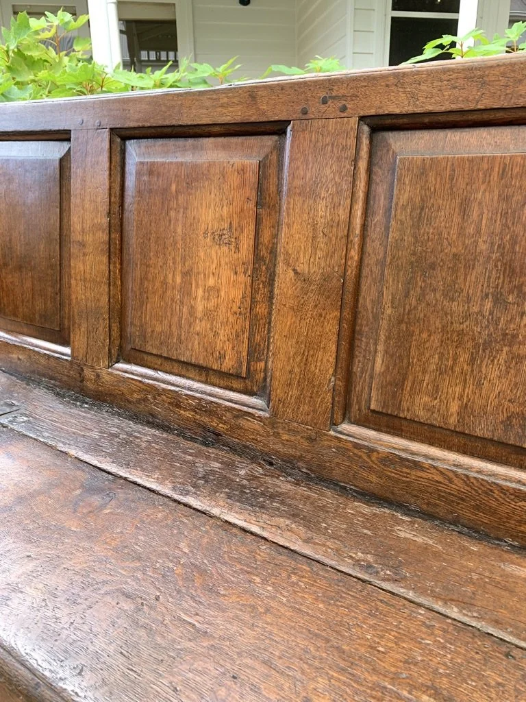Fielded panel detail and seat patina antique English oak box settle circa 1680-1720