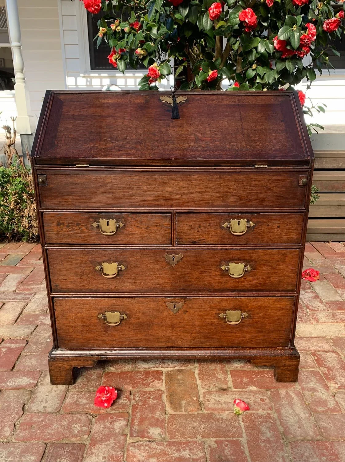 Georgian oak bureau chest with brass hardware and bracket feet