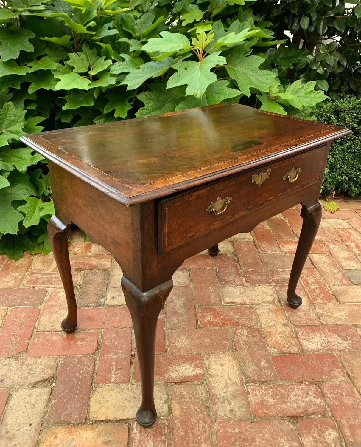 Georgian oak side table or low boy with a single drawer and cross banded and inlaid top with cabriole legs