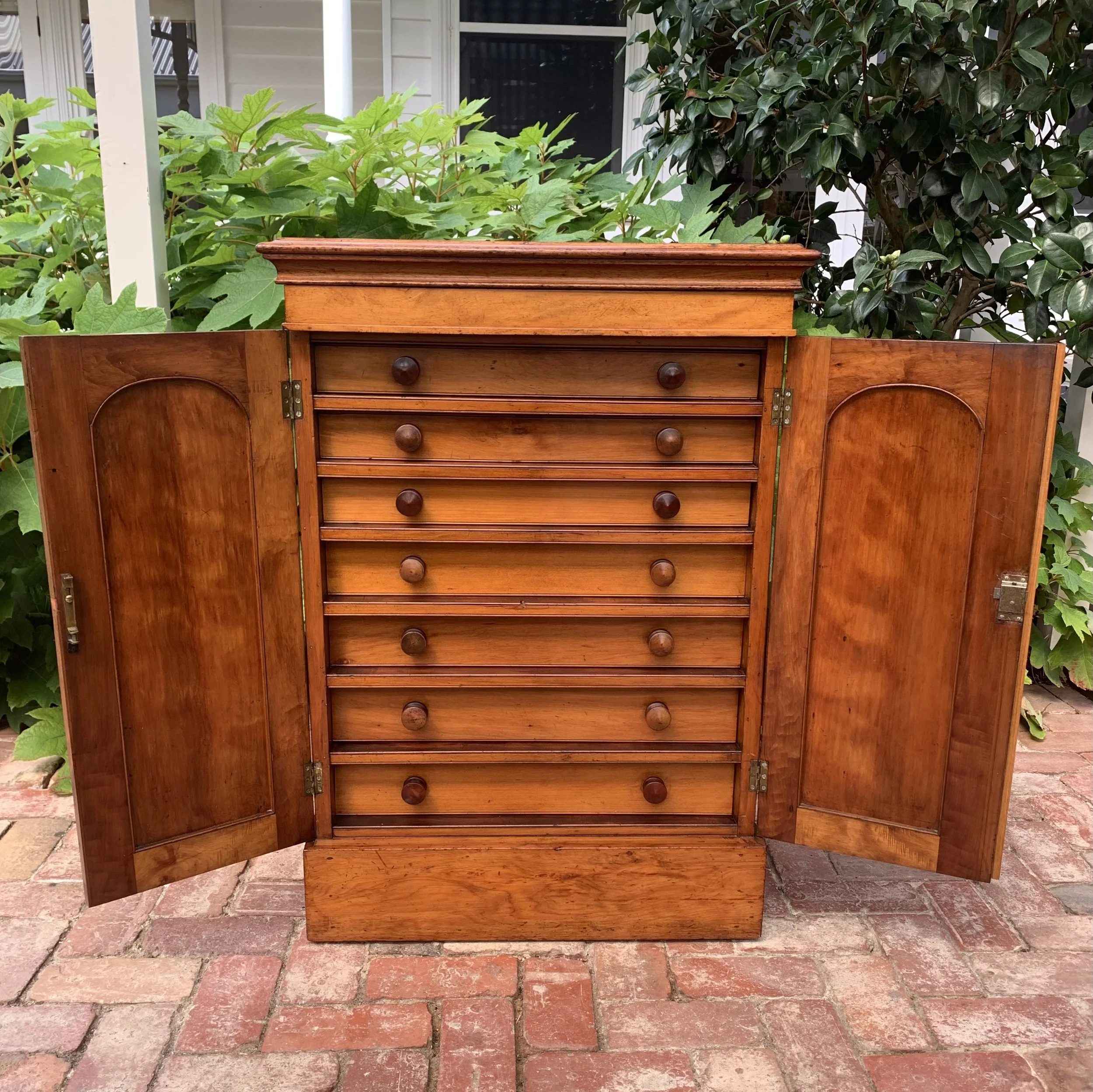 Front view with doors open of cedar and walnut antique collector's chest 