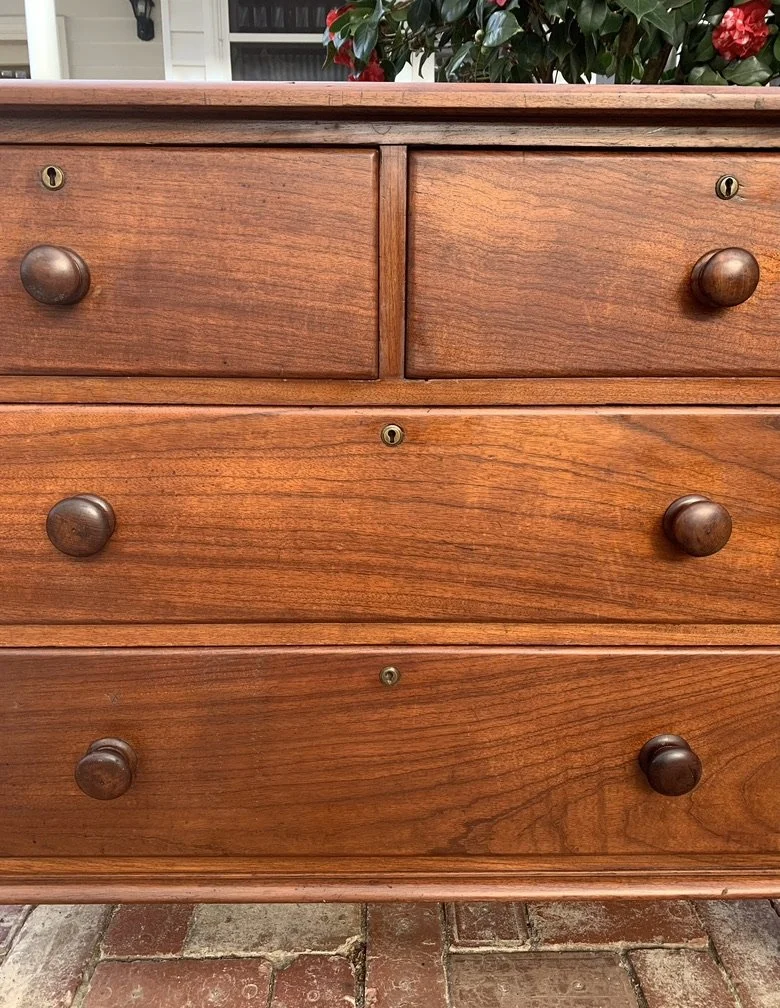 Close-up of solid cedar drawer fronts on antique Australian chest, timber knob handles and brass escutcheons