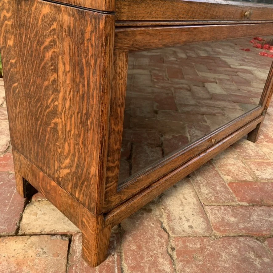Close-up of plinth base and tapered foot on antique English oak lawyer's bookcase