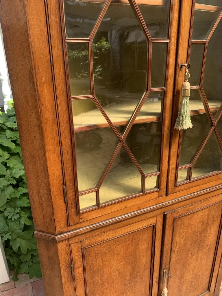 close up of glazed section of georgian oak corner cabinet