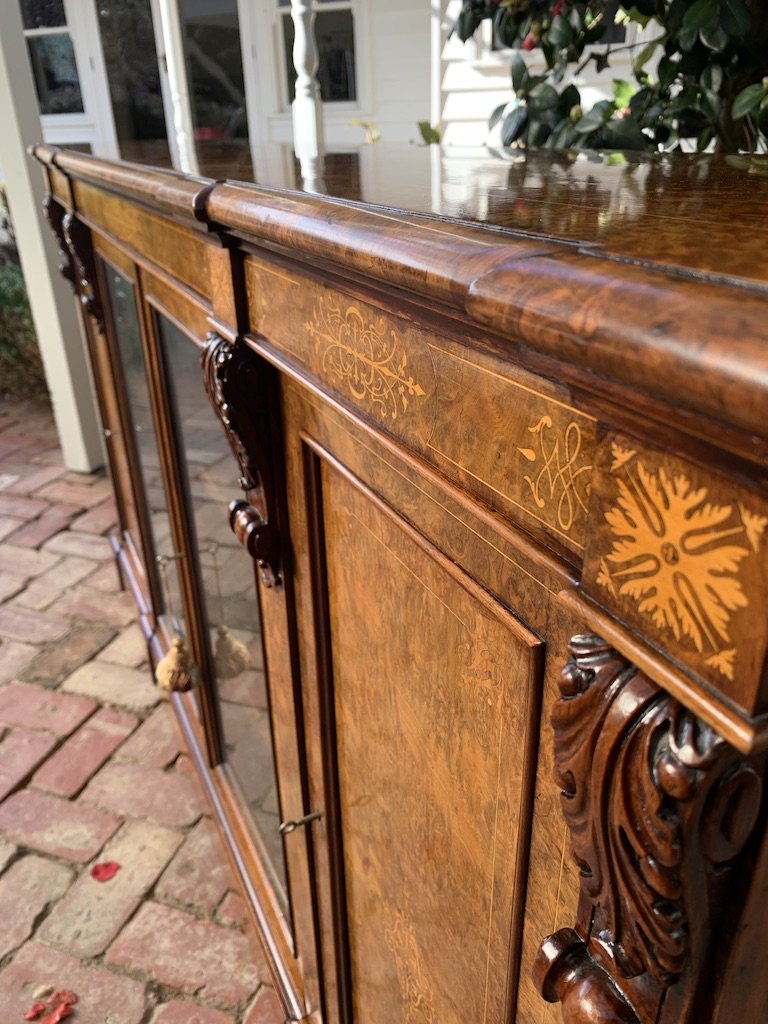 Satinwood marquetry inlay and carved corbel detail on Victorian burr walnut breakfront dwarf bookcase