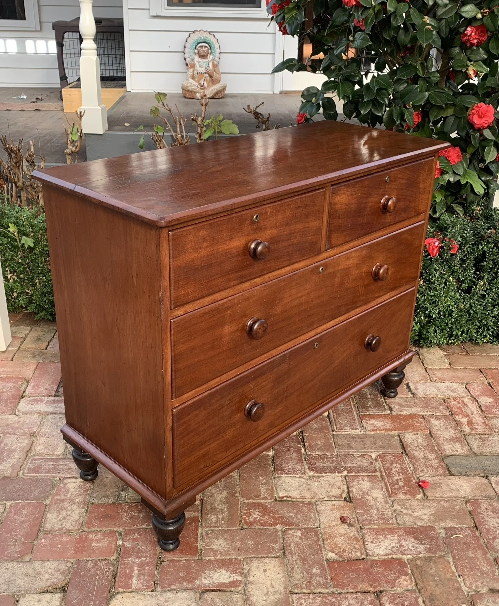 Colonial Australian cedar chest of drawers side view showing turned bun feet and moulded top
