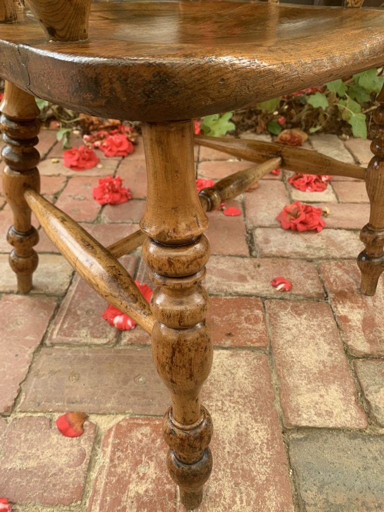 Detail of baluster-turned oak leg and h stretcher on antique Windsor chair