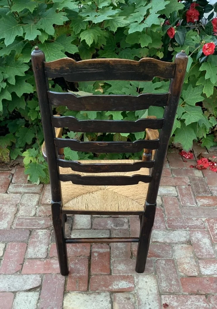 Full back view of the antique Georgian ladder-back chair showing the detailed construction of the six horizontal wavy slats and the rear legs.