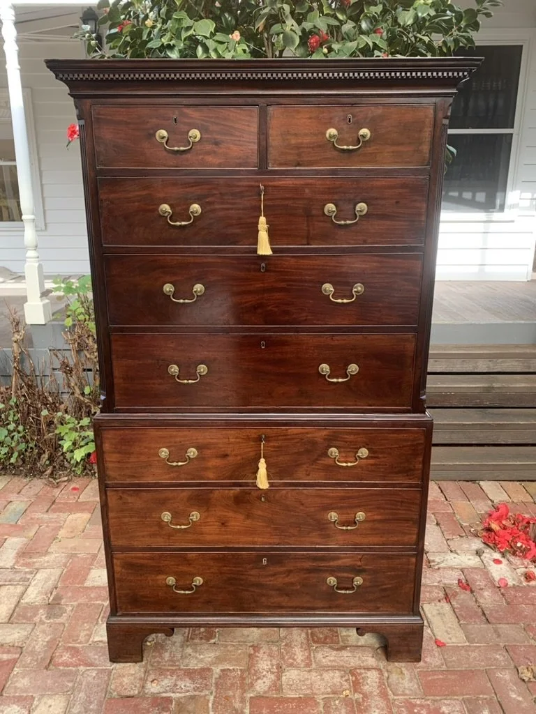 Front view of an English George III mahogany chest on chest with original hardware and bracket feet