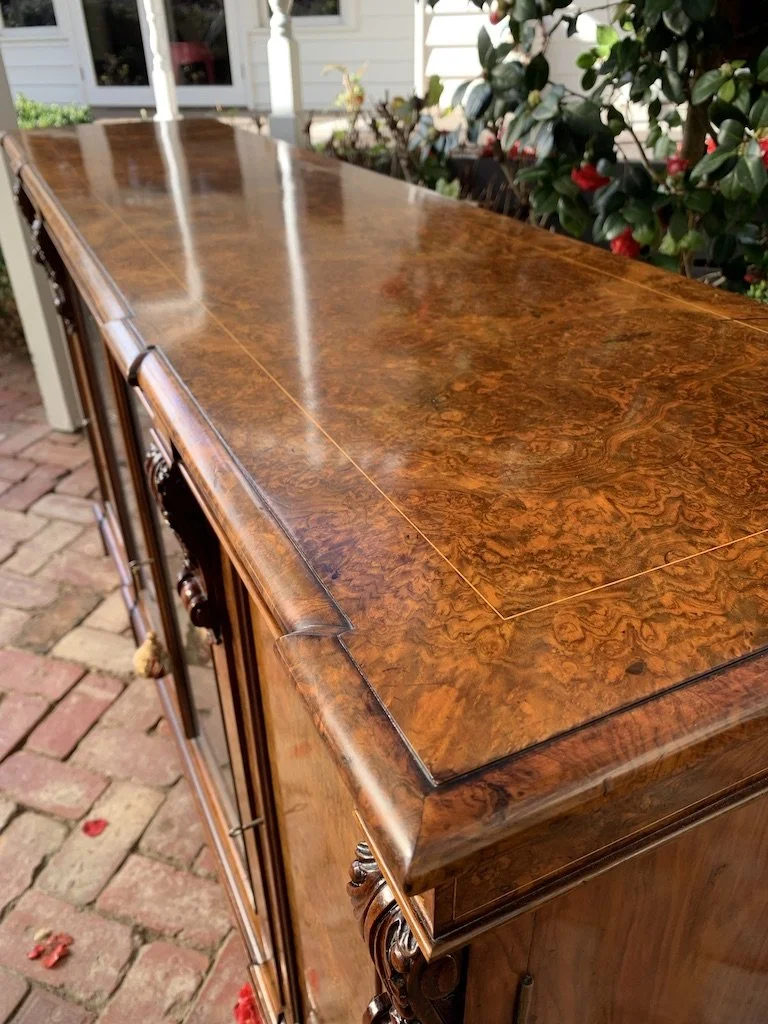 Close-up of burr walnut veneer figuring and satinwood line inlay, Victorian breakfront bookcase top corner detail