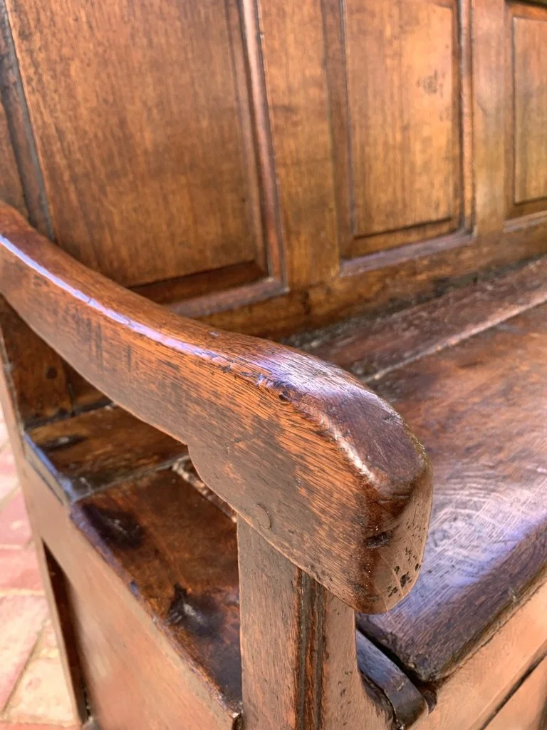 Hand-worn oak arm detail 17th century English box settle original patina