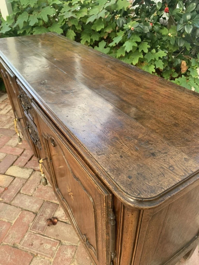 Top surface and corner view of antique French oak buffet showing timber grain and star inlay