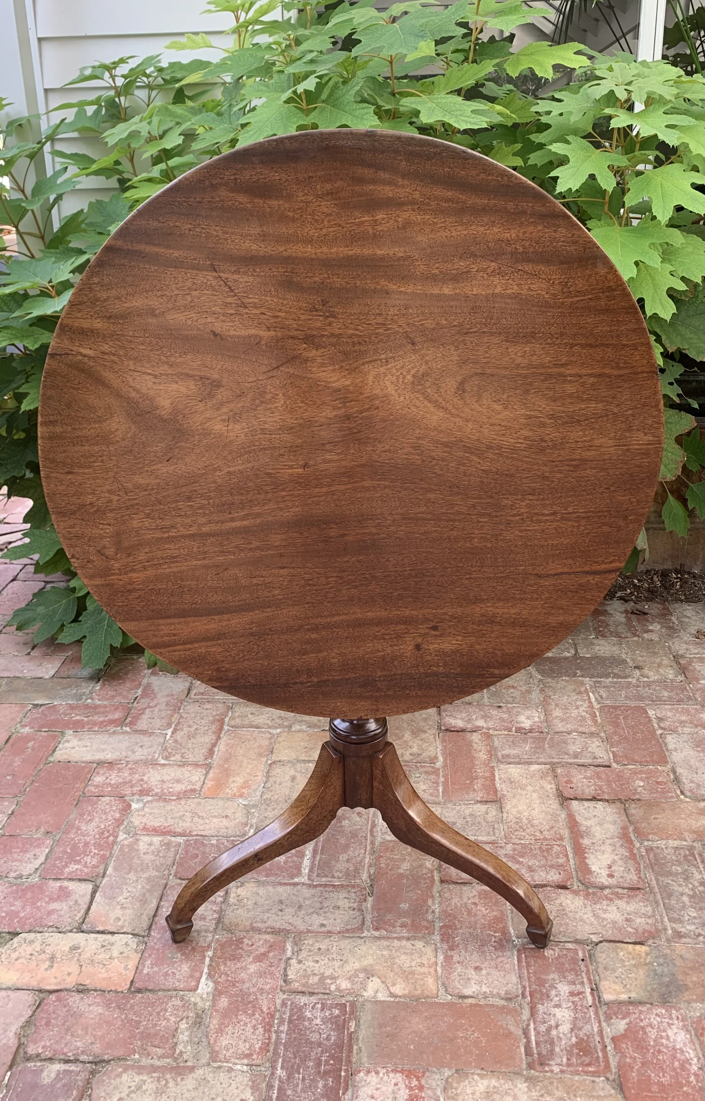 Georgian mahogany tilt-top wine table with  urn turned column and swept tripod legs in the tilted position  