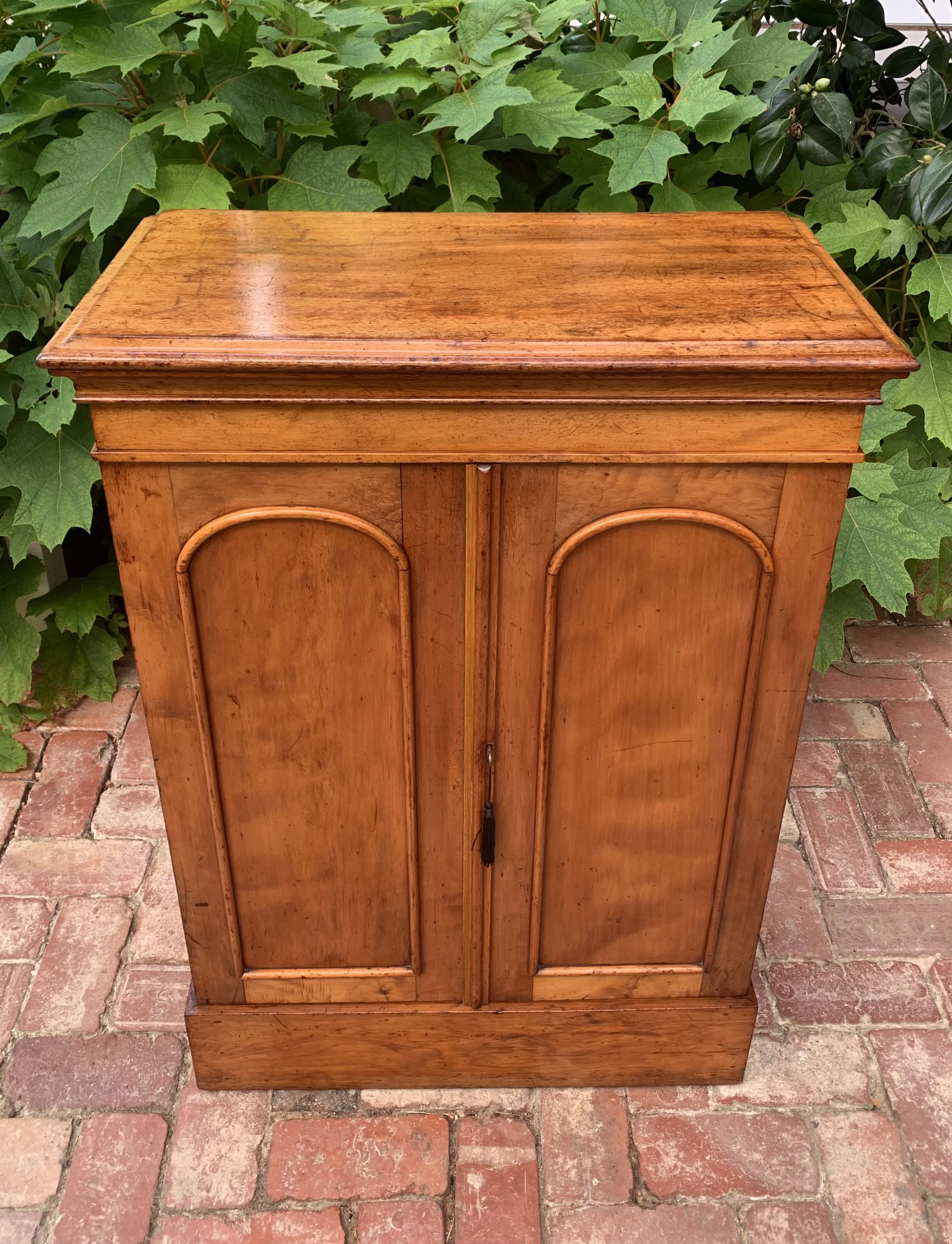 front view of late 19th century cedar and walnut collector's cabinet with doors closed 