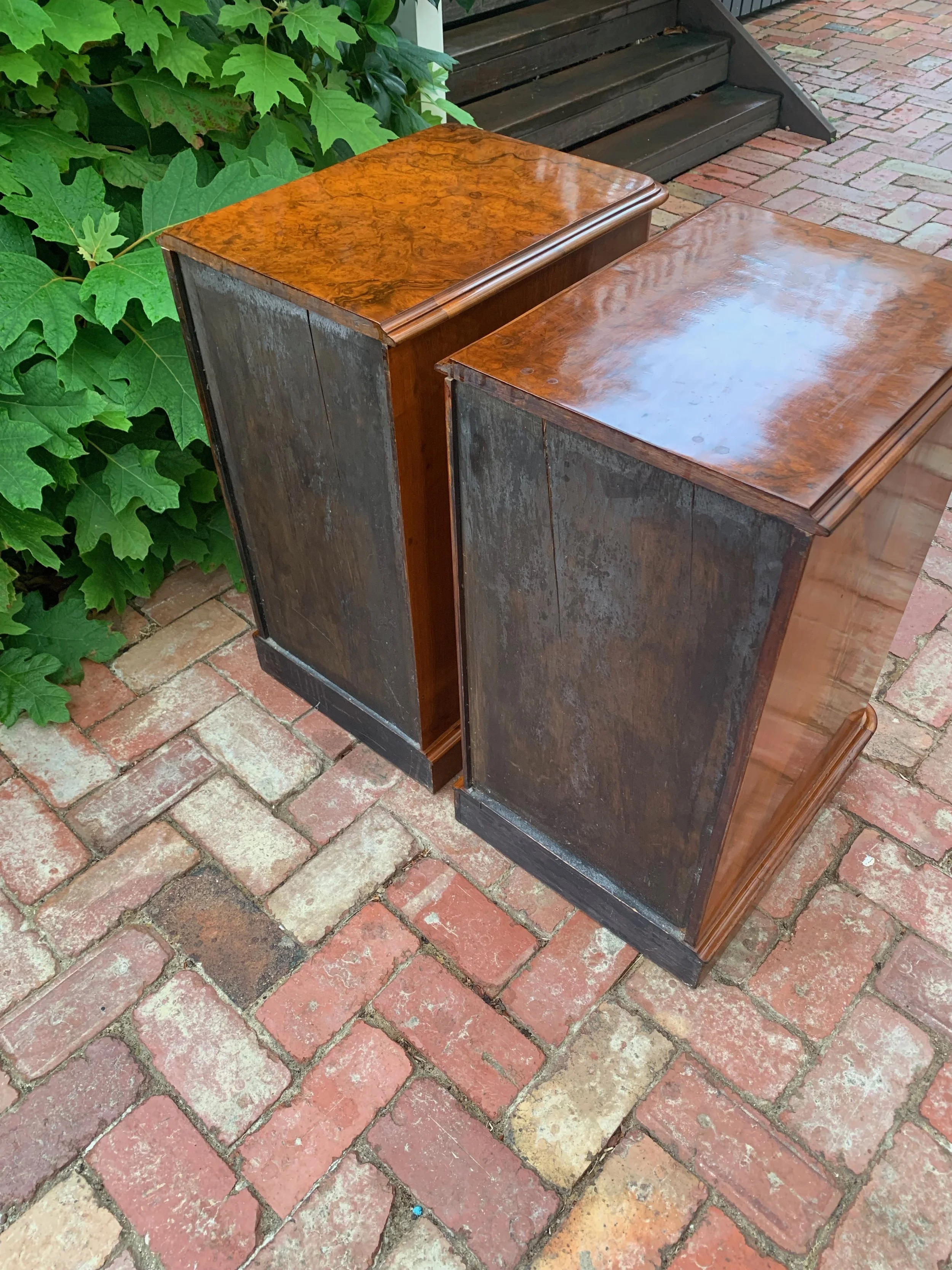 view of backs of pair of antique burr walnut bedside chests with graduating drawers and turned knobs circa 1870 