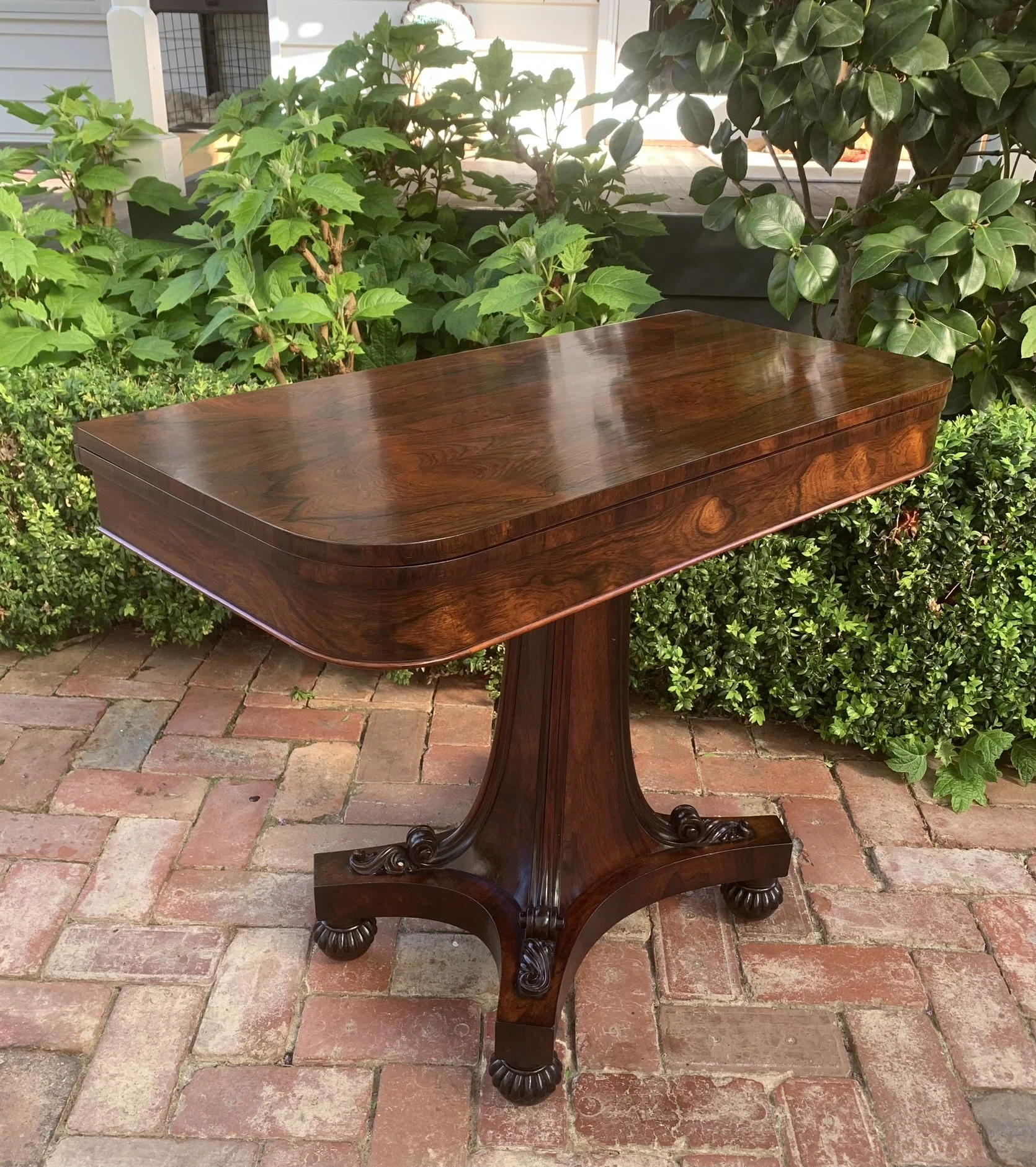 William IV rosewood card table showing figured top and reeded pedestal base