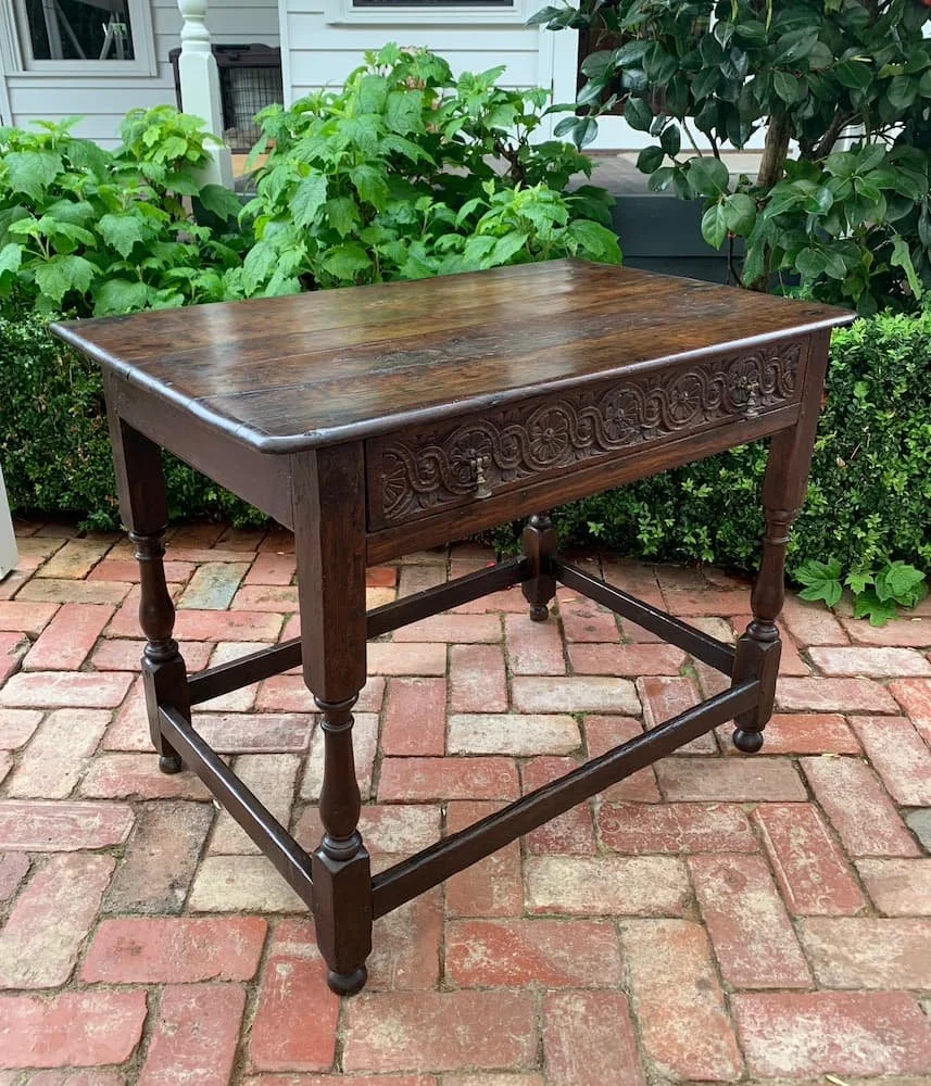 Early 18th century English oak side table with carved guilloche drawer, turned legs and box stretcher