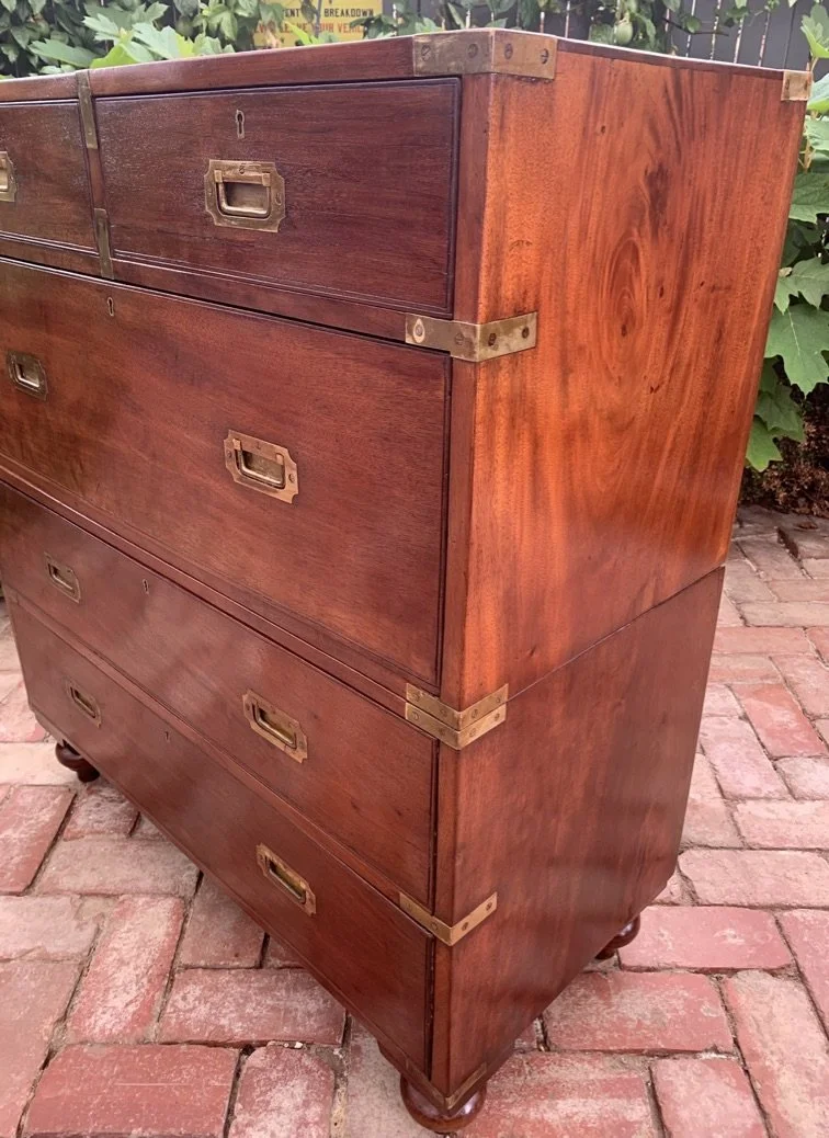 Antique two-section campaign chest figured mahogany side panel brass corner mounts bun feet c.1890