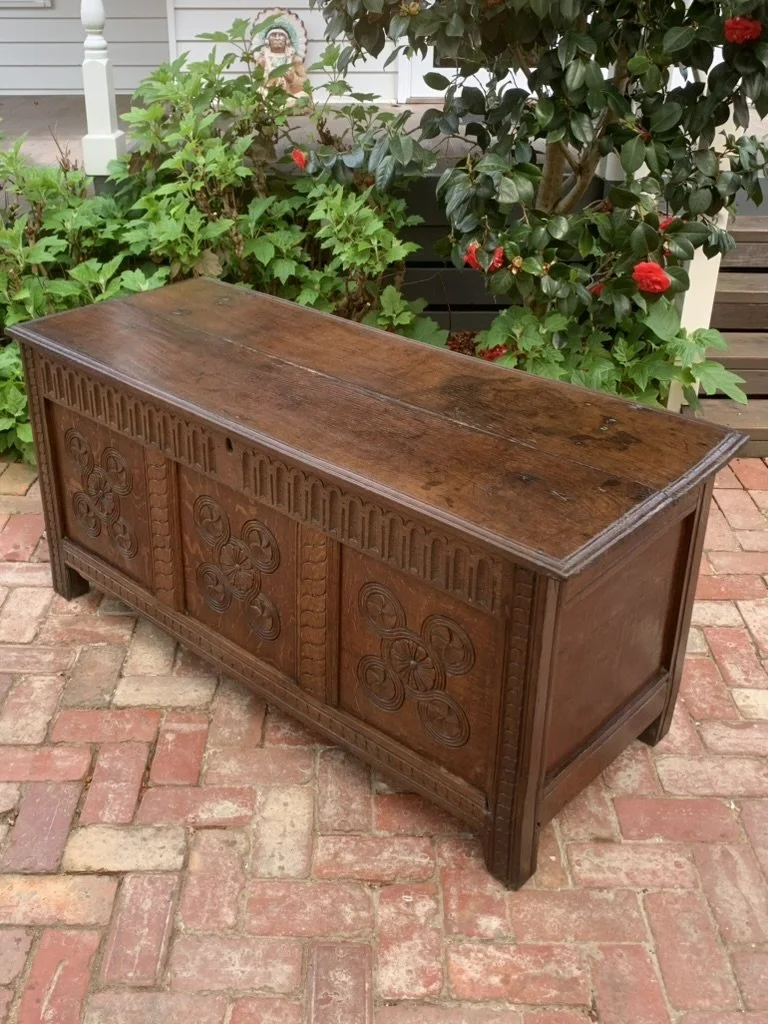 17th century oak coffer C.1680-1720, antique oak blanket box with carved front, moulded two plank lid, panelled end