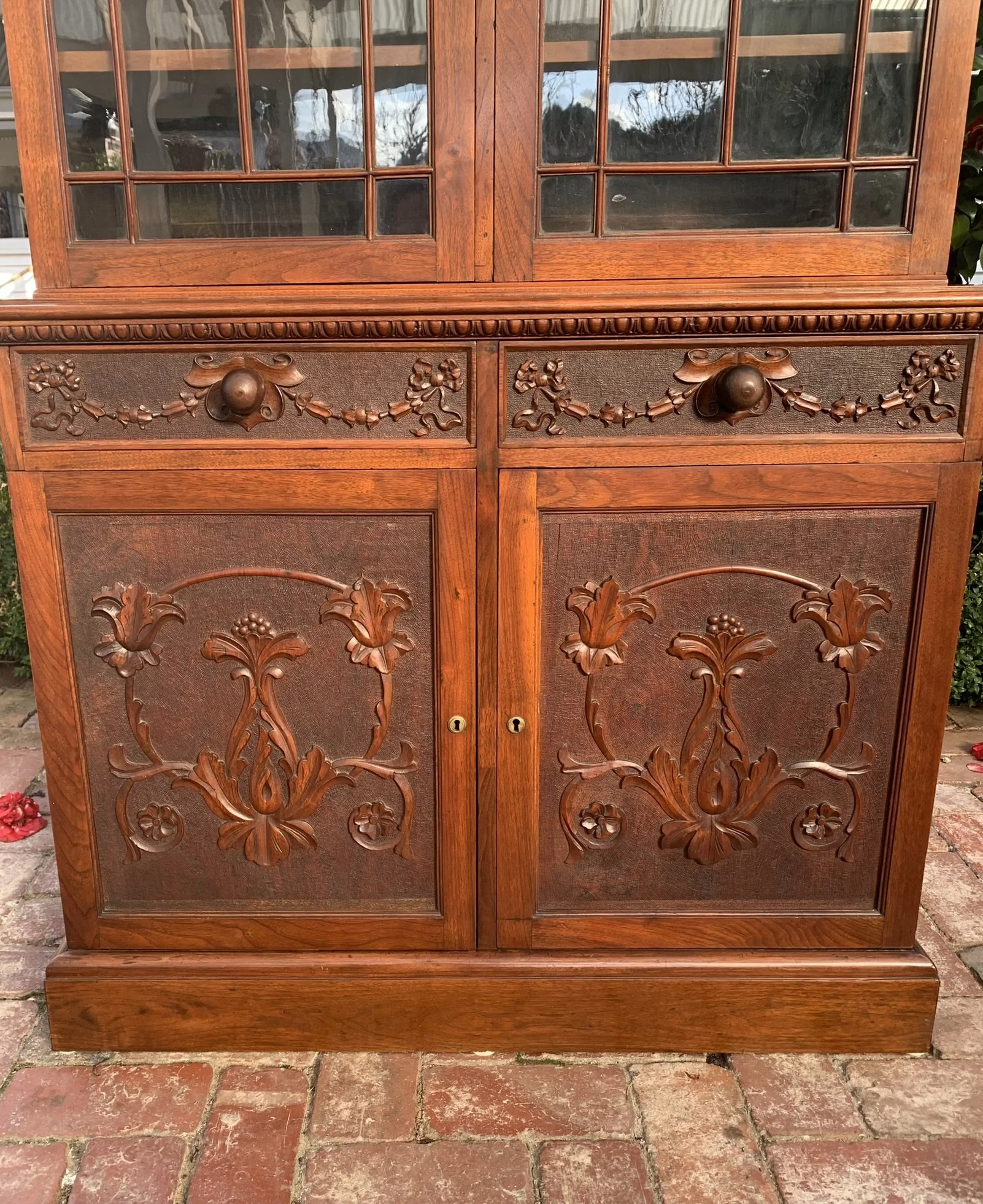 Edwardian walnut bookcase C.1910 carved Art Nouveau floral panel cupboard doors detail