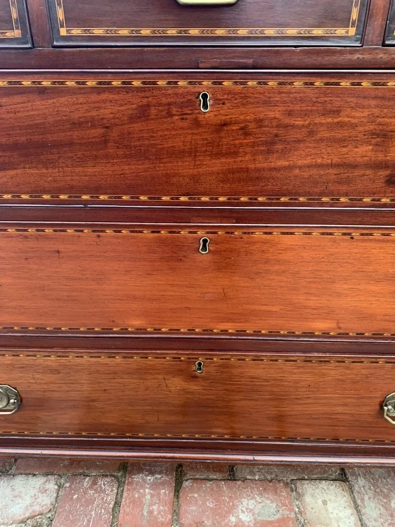 close up view of chevron inlaid drawer fronts of georgian mahogany chest of drawers