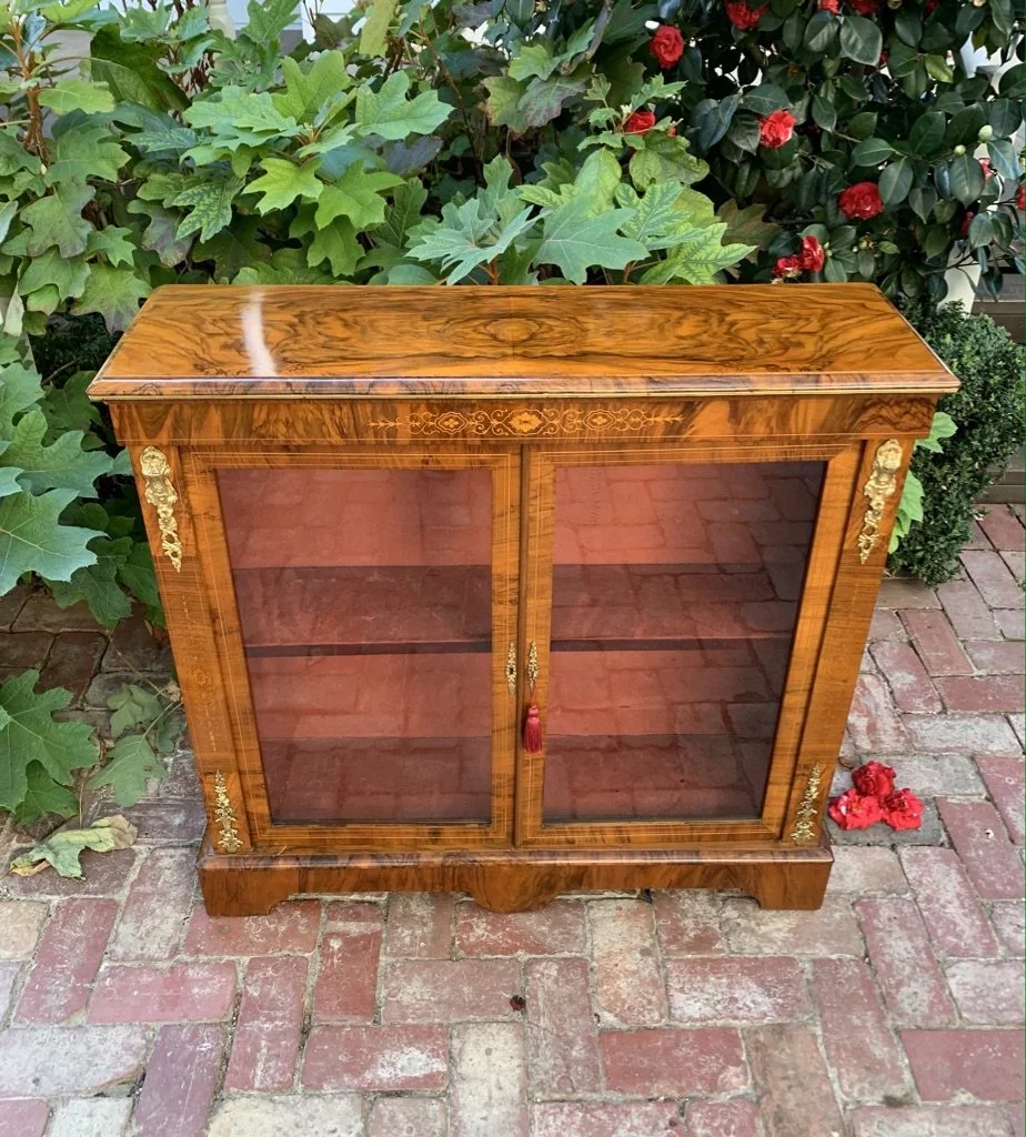 Victorian figured walnut pier cabinet with glazed double doors single shelf and ormolu mounts