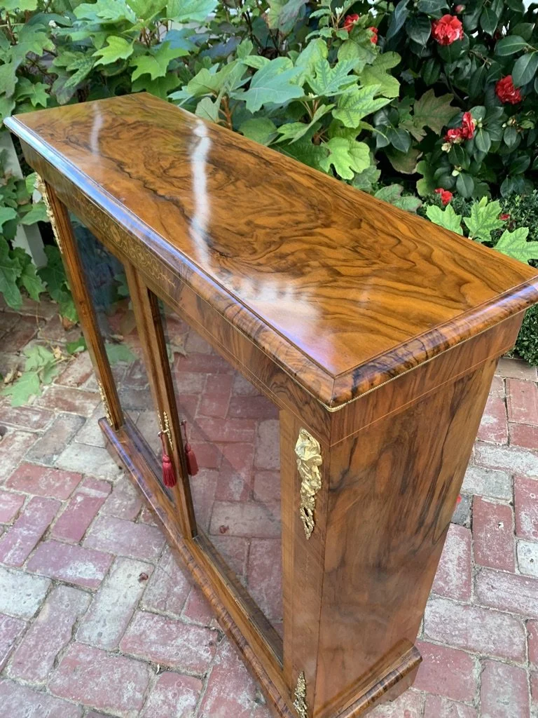 view of figured walnut grain on Victorian figured walnut pier cabinet with glazed double doors single shelf and ormolu mounts