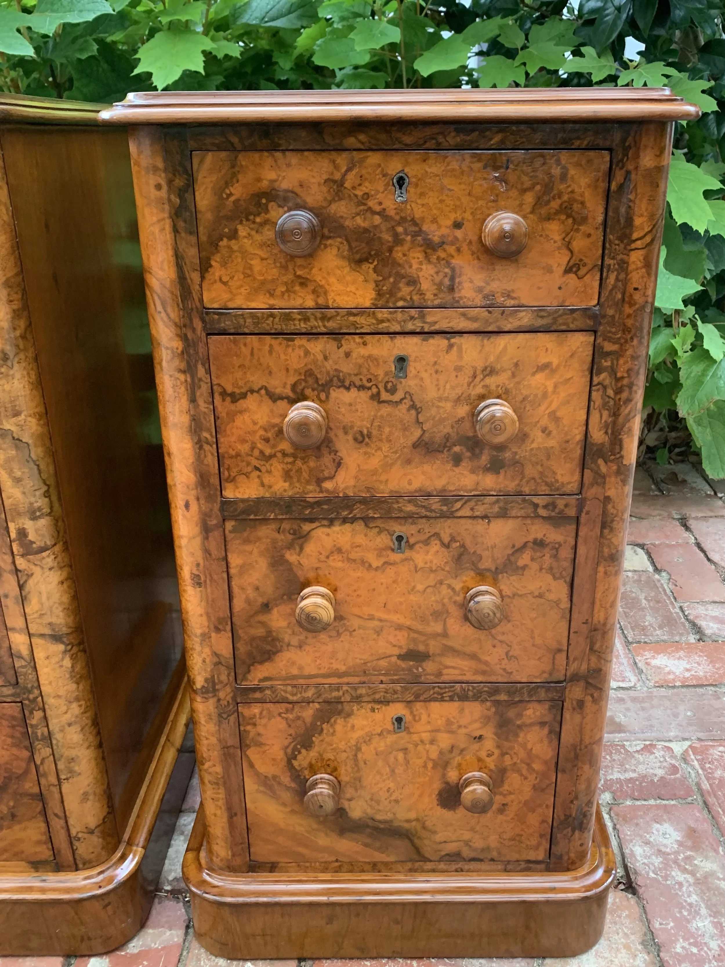 close up of drawer front of right hand chest of victorian burr walnut bedside chests with graduating drawers and turned knobs circa 1870 