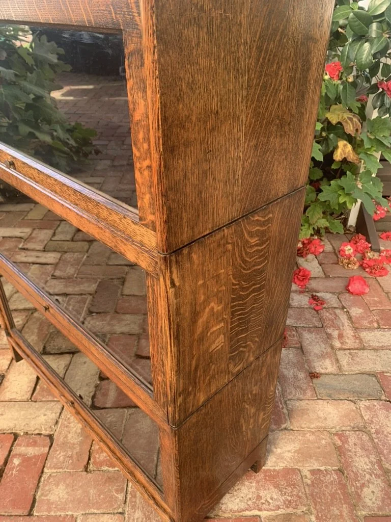 Side profile of English oak stacking lawyer's bookcase showing sectional construction and glass door joinery