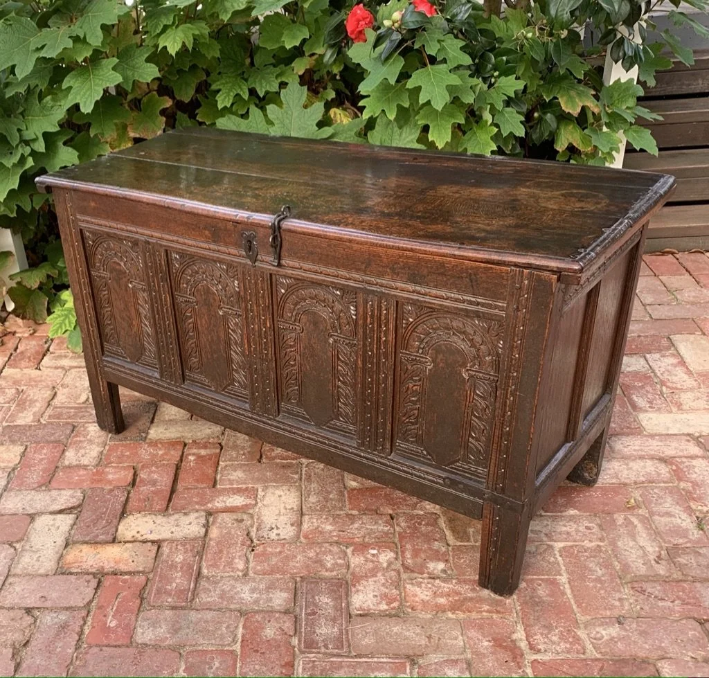 17th-century English oak coffer left three-quarter view carved arcaded panels plain end panel c.1660