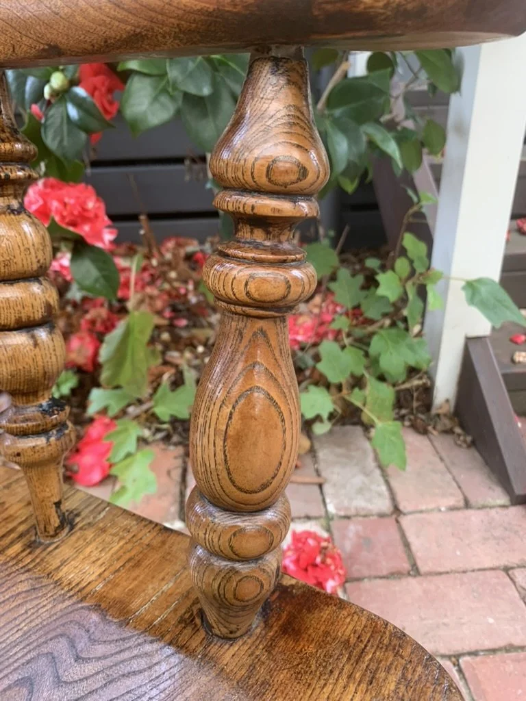 Close-up of baluster turned support on antique broad arm Windsor armchair