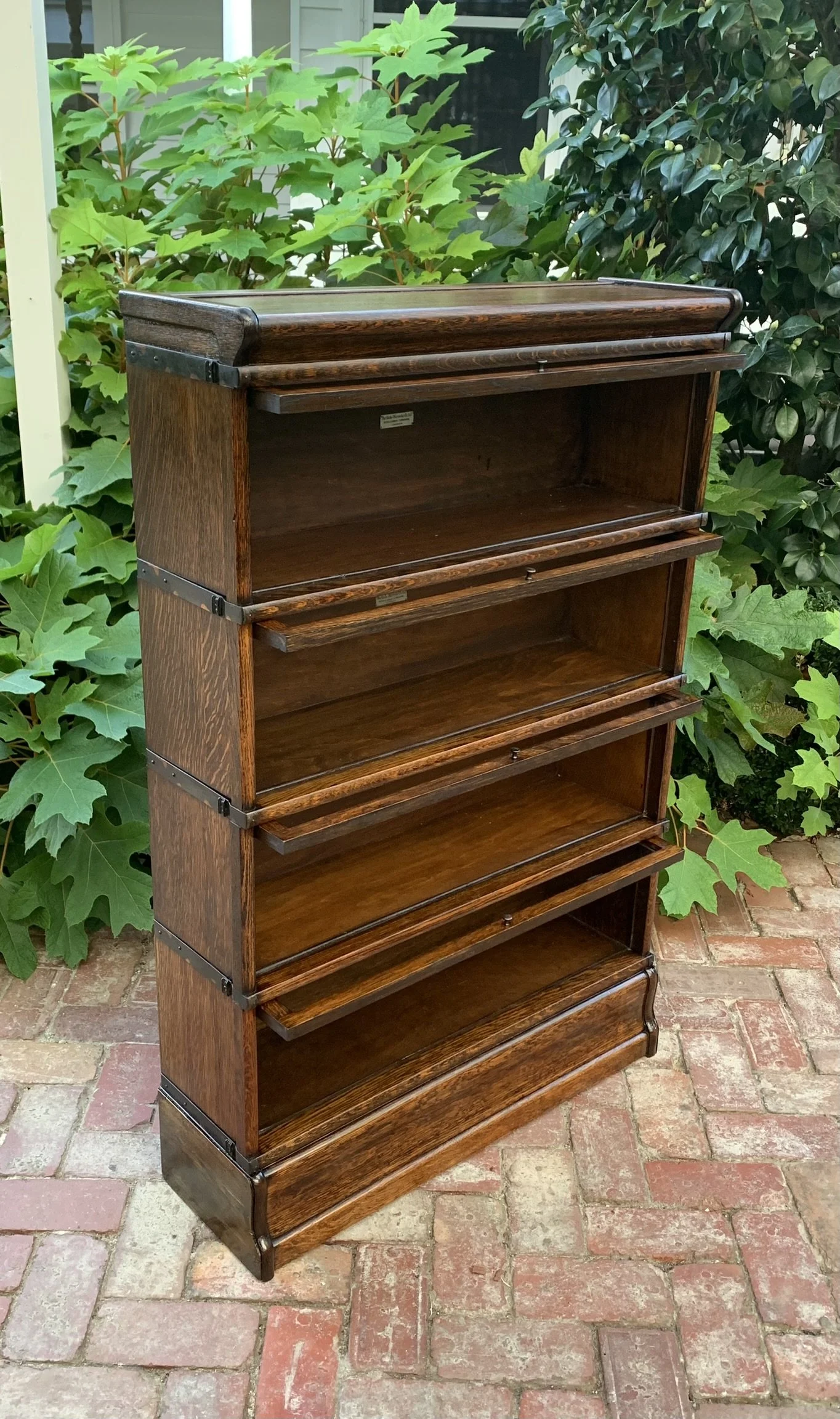 Antique oak barrister bookcase with doors open showing shelving, Globe-Wernicke four-section stacking bookcase c.1910